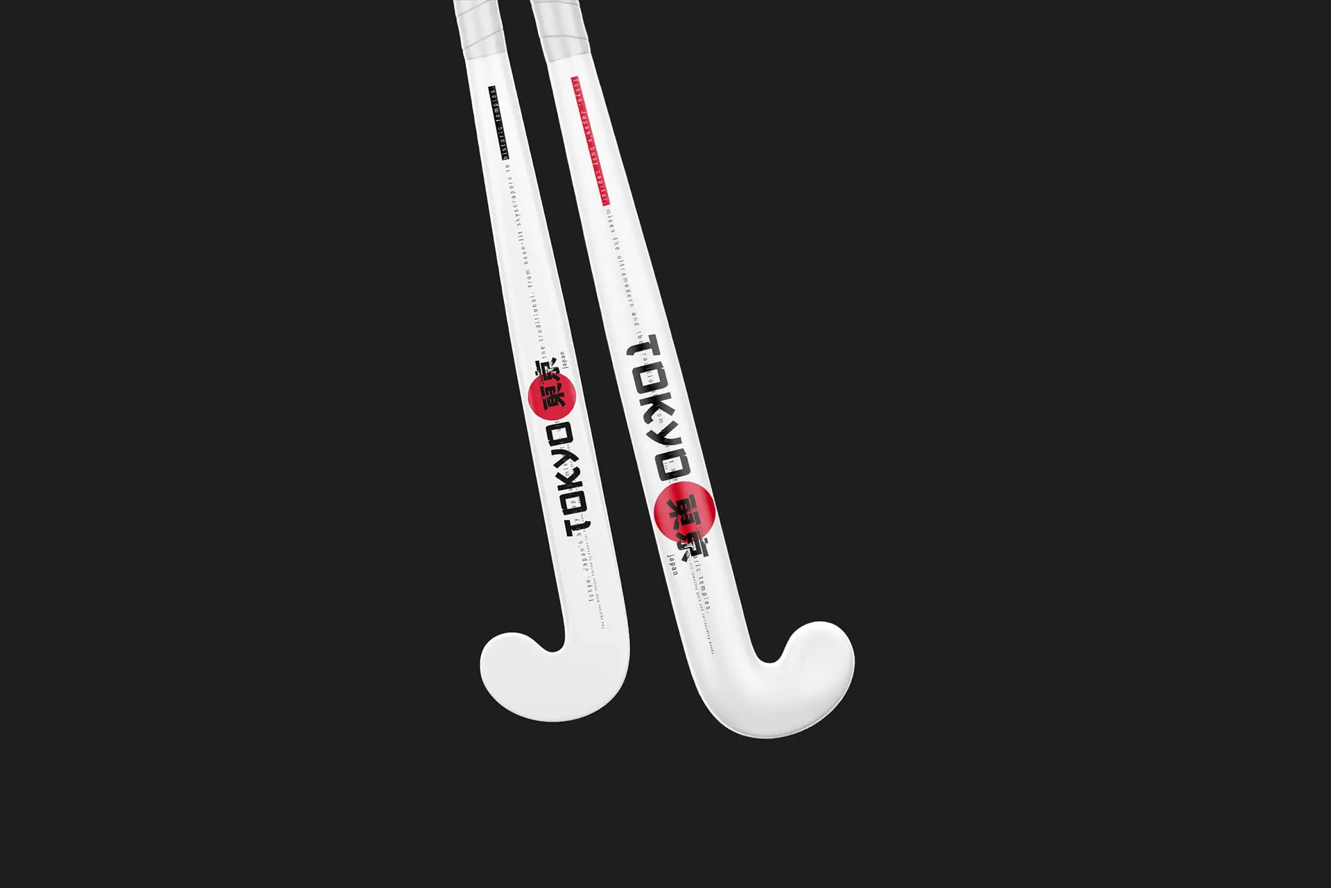 Custom-designed RAGE outdoor field hockey sticks featuring bold "TOKYO" vertical lettering and Japanese kanji characters on a sleek black and white frame.