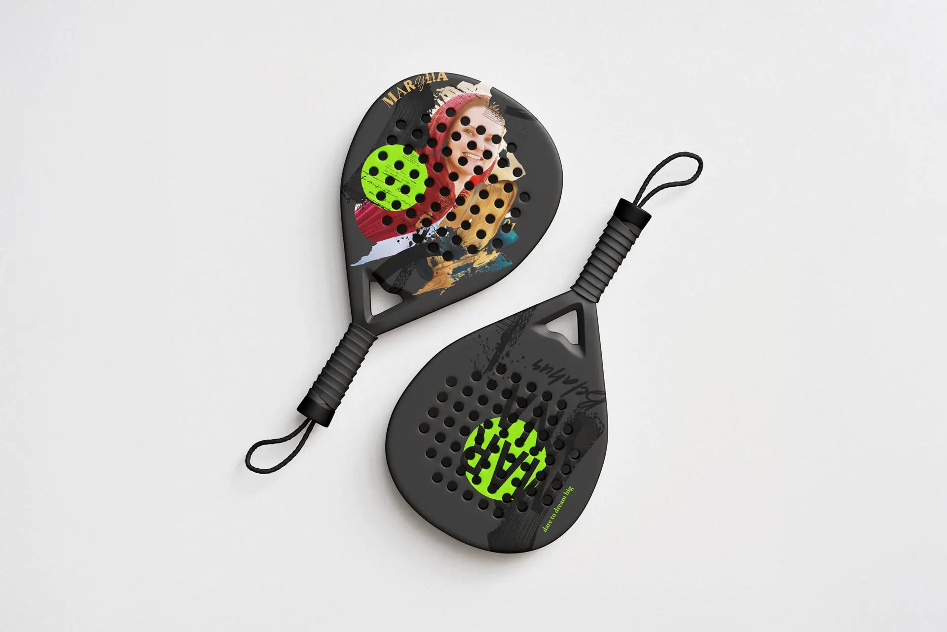 Two padel tennis rackets arranged diagonally on a clean, light gray surface. The top racket features a teardrop shape with a carbon fiber pattern, a lime green circular accent with branding on the face, and a black and neon green safety wrist strap attached to the handle. The bottom racket is round-shaped, predominantly matte black with a distinctive lime green geometric logo in the center of the perforated face and a solid black wrist strap.
